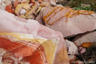 Red, pink, and yellow swirls in sandstone.