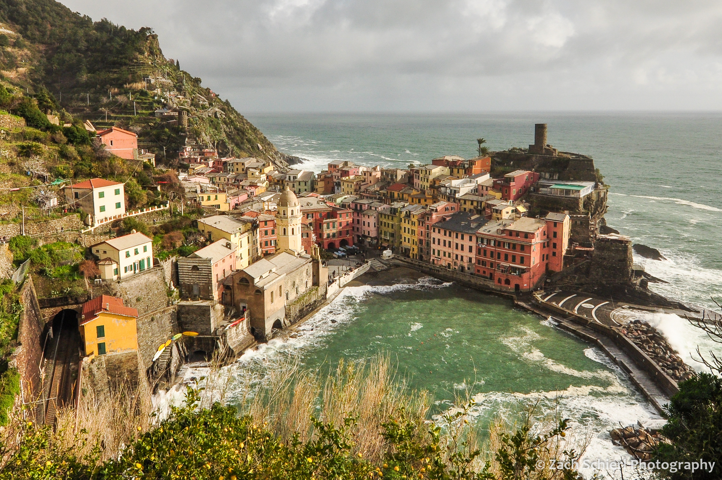 Coloful buildings line the harbor in the village of Vernazza